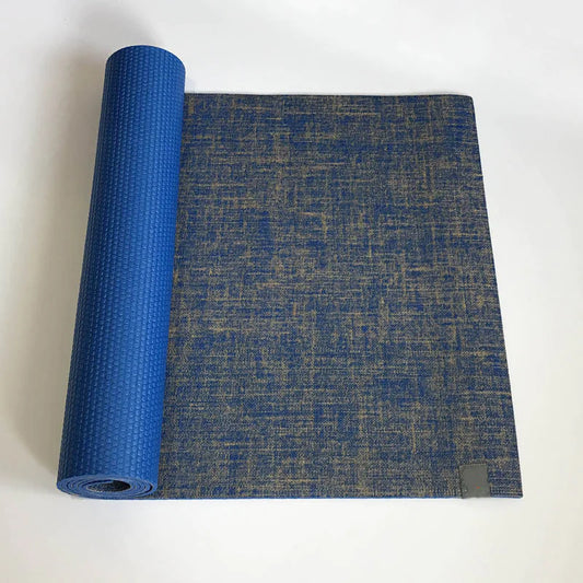 Blue textured yoga mat rolled out on a white background