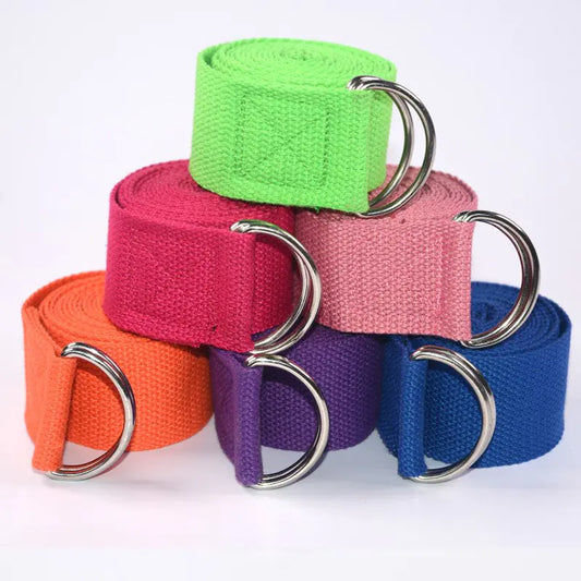 Four colorful yoga straps with metal D-rings on a white background