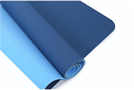 Blue yoga mat rolled up on a white background